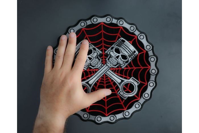 Piston Web Skulls Large Back Patch shown on hand for size comparison