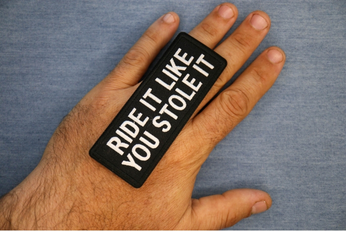 Ride It Like You Stole It Patch, Biker Saying Patches shown on hand for size comparison
