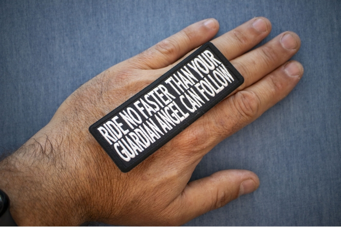 Ride No Faster Than Your Guardian Angel Can Follow Patch, Biker Saying Patches shown on hand for size comparison