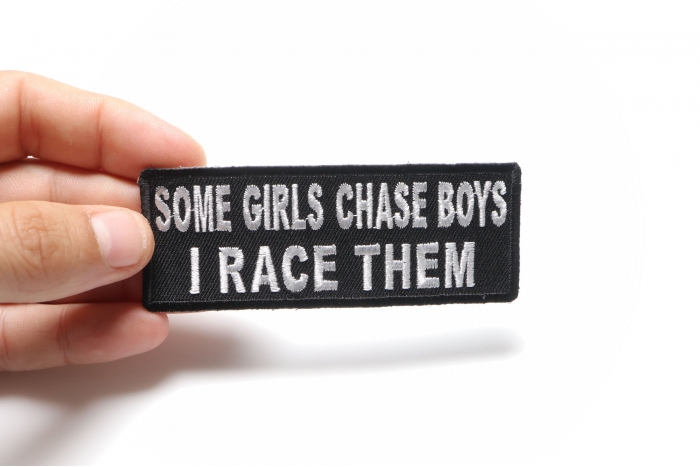 Some Girls Chase Boys I Race Them Patch, Biker Saying Patches shown on hand for size comparison