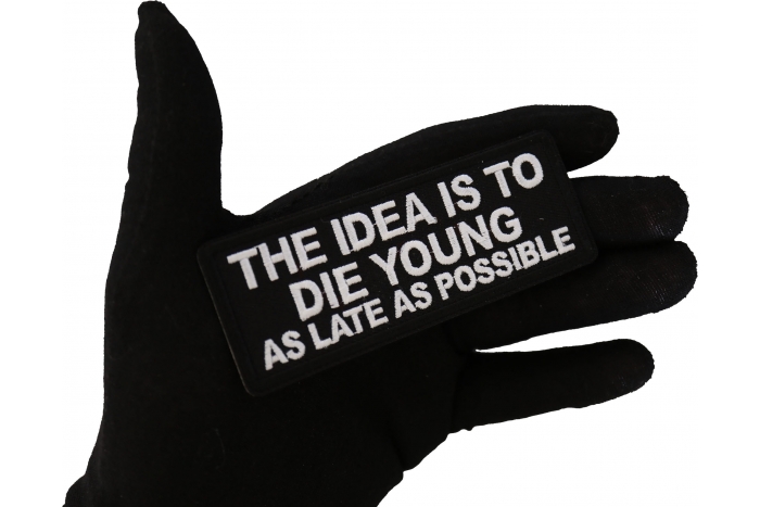 The Idea is to Die Young as Late as Possible Patch, Biker Saying Patches shown on hand for size comparison