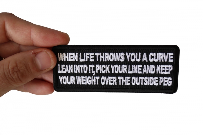 When Life throws you a curve, Lean into it, Pick your line and keep your weight over the outside Peg Patch, Biker Saying Patches shown on hand for size comparison