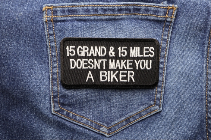 15 Grand 15 Miles Doesn't Make You A Biker Patch shown on jeans