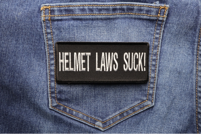 Helmet Laws Suck Patch shown on jeans