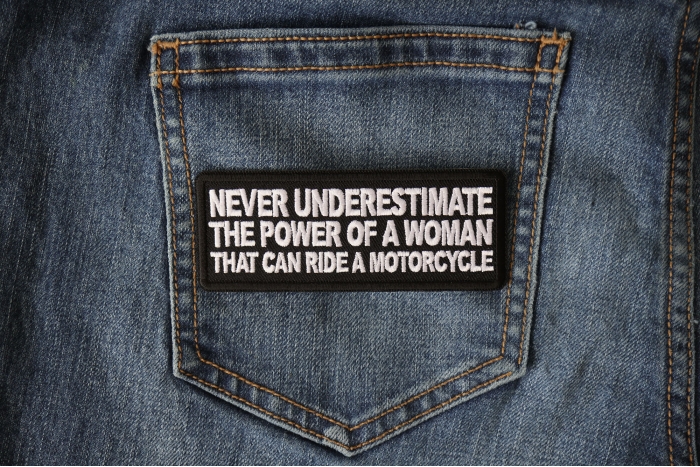 Never Underestimate the Power of a Woman That Can Ride a Motorcycle Patch shown on jeans
