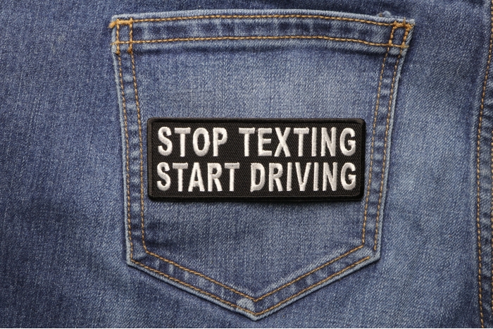 Stop Texting Start Driving Patch shown on jeans