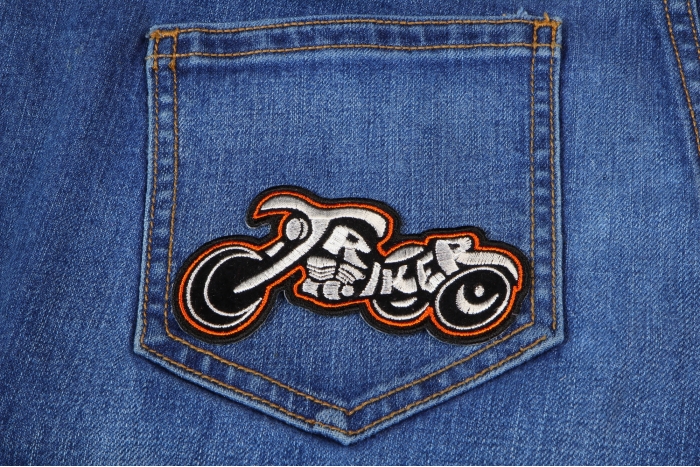 Triker Small Biker Patch In White and Orange shown on jeans