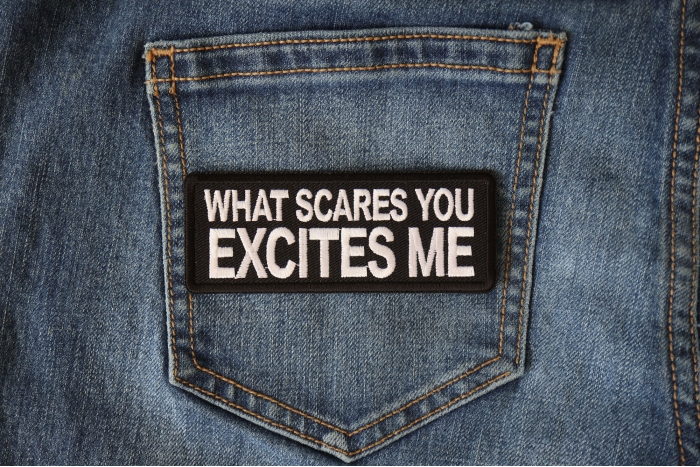 What Scares you Excites Me Patch shown on jeans