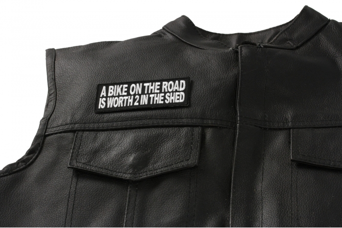 A Bike On The Road Is Worth 2 In The Shed Patch - Iron on Patch - 4x1.5 in shown on leather vest