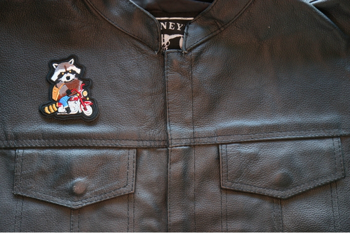 Motorcycle Jacket/Vest Embroidered Biker Patch - Raccoon Biker on Motorcycle Patch shown on leather vest