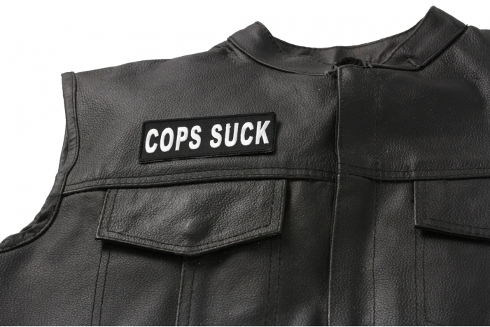 COPS SUCK Patch - Iron on Patch - 4x1.5 inch shown on leather vest