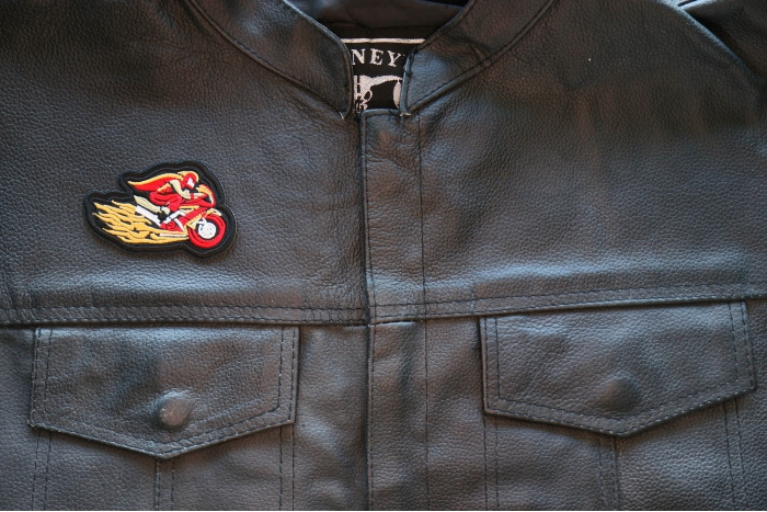 Motorcycle Jacket/Vest Embroidered Biker Patch - Red Cape Biker on Motorcycle Patch shown on leather vest