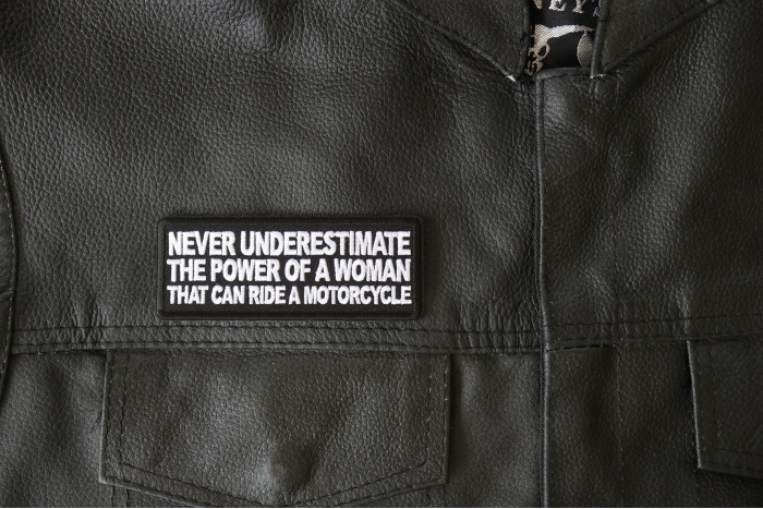 Never Underestimate the Power of a Woman That Can Ride a Motorcycle Patch, Biker Saying Patches shown on leather vest