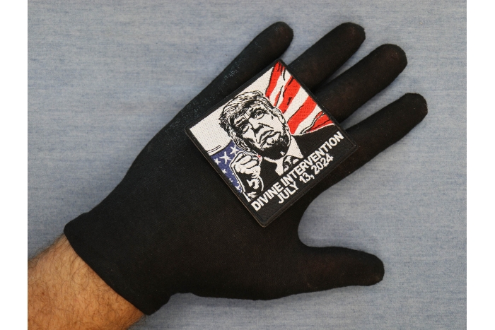 Divine Intervention Trump Patch shown on hand for size comparison