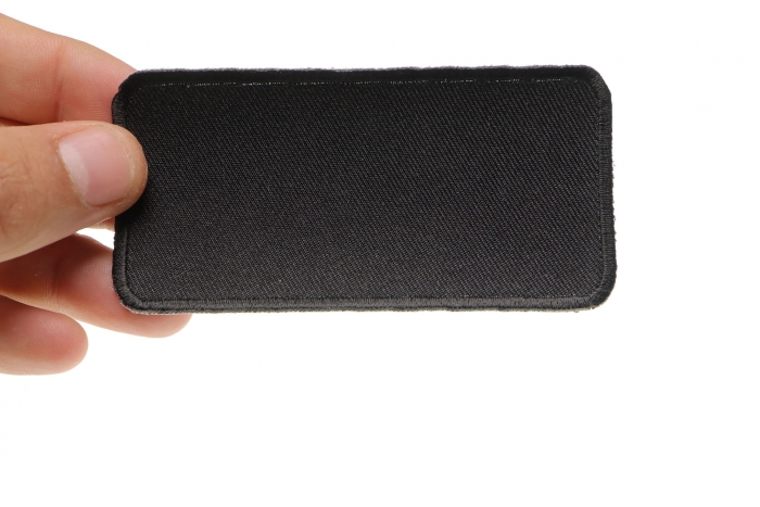Black 4 Inch Rectangular Blank Patch shown on hand for size comparison