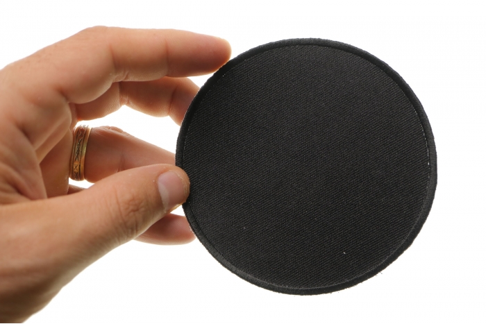 Black 4 Inch Round Blank Patch shown on hand for size comparison