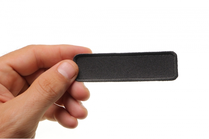 Black Name Tag Blank Patch shown on hand for size comparison