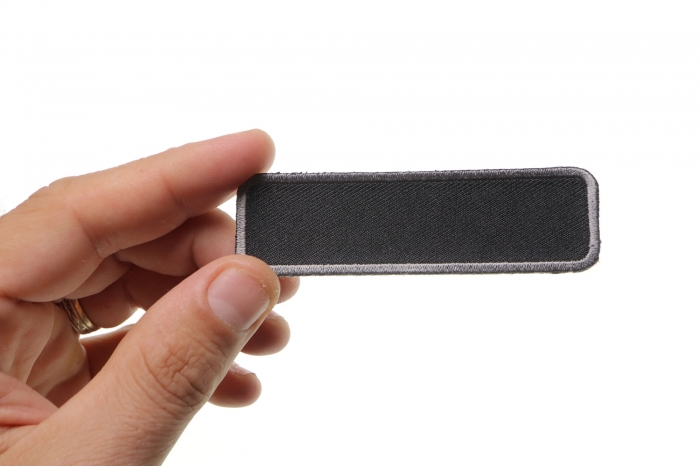 Blank Name Tag Patch Gray Border shown on hand for size comparison