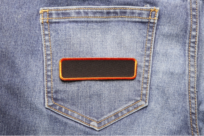 Blank Name Tag Patch Orange Border shown on jeans