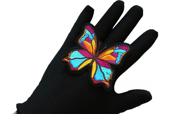Butterfly Iron on Patch shown on hand for size comparison