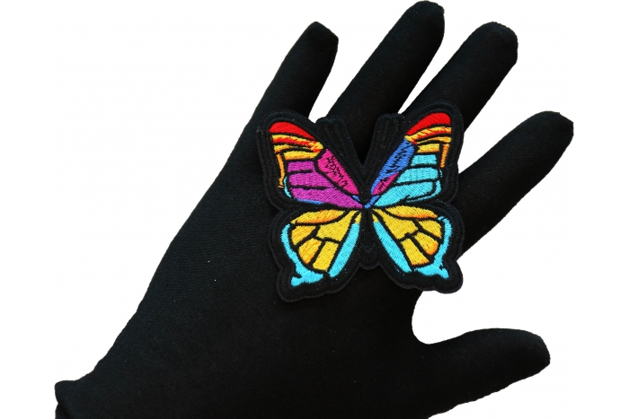 Stained Glass Butterfly Iron on Patch shown on hand for size comparison