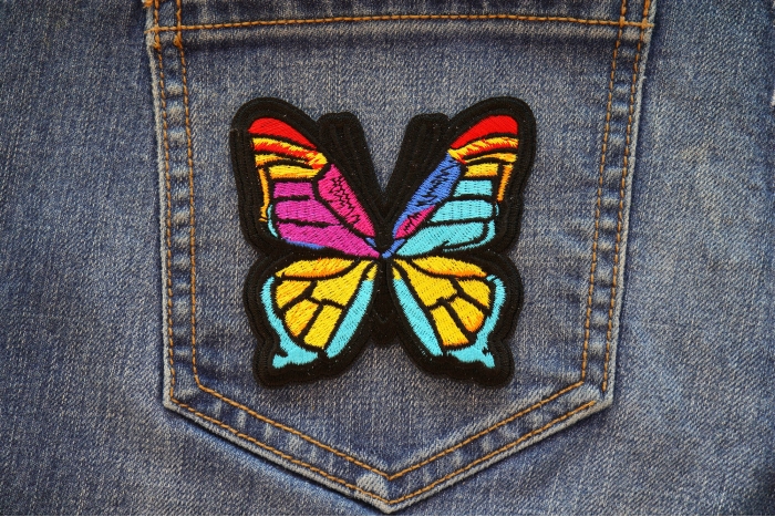 Stained Glass Butterfly Iron on Patch shown on jeans