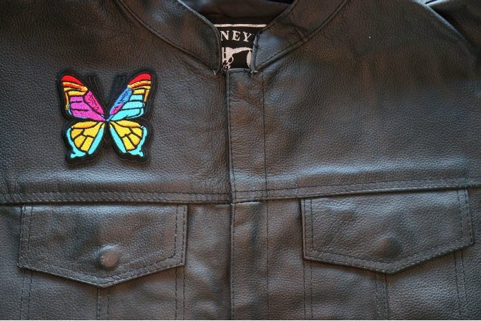 Stained Glass Butterfly Iron on Patch shown on leather vest