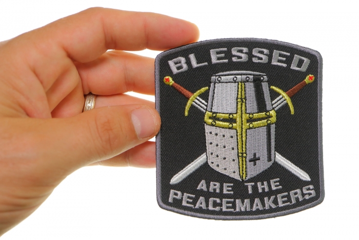 Blessed Are The Peacemakers Knight Christian Patch shown on hand for size comparison