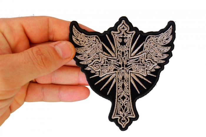 Christian Cross with Wings Patch shown on hand for size comparison