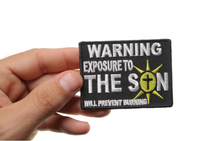 Exposure To The Son Christian Patch shown on hand for size comparison