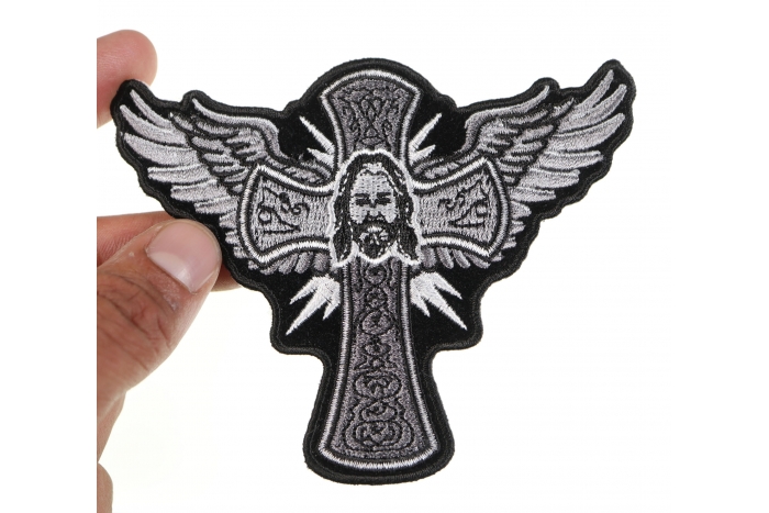Jesus Cross and Wings Iron on Patch shown on hand for size comparison