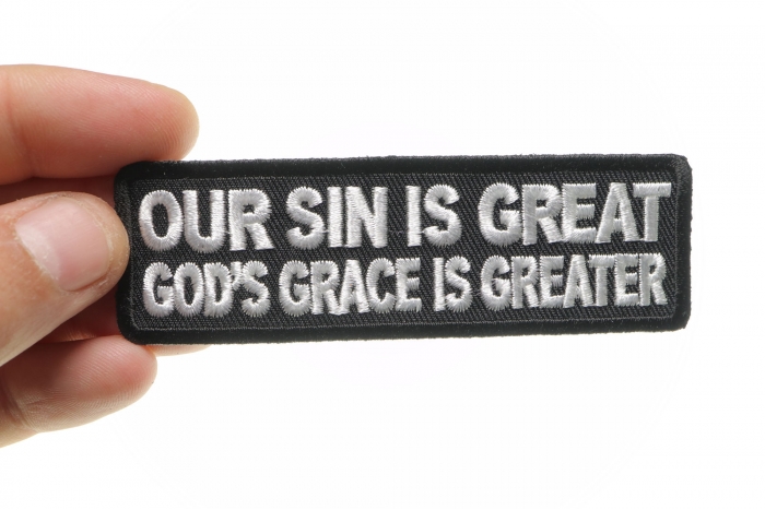 Our Sin Is Great Gods Grace Is Greater Patch shown on hand for size comparison