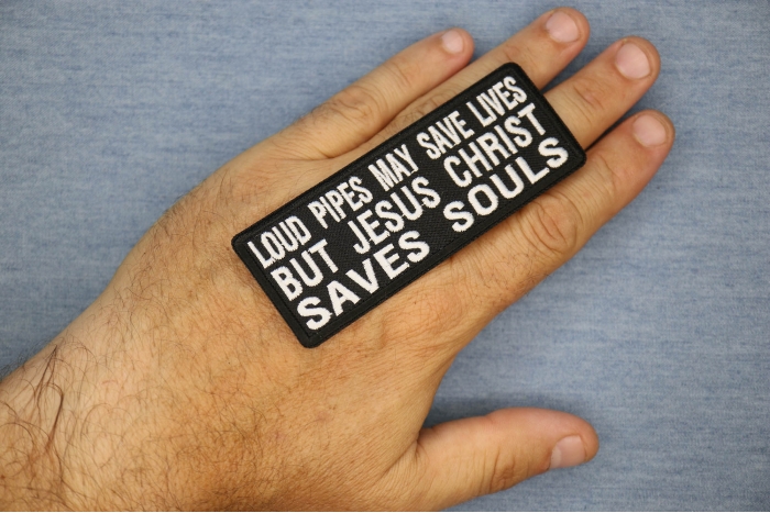 Loud Pipes May Save Lives But Jesus Christ Saves Souls Patch, Christian Saying Patches shown on hand for size comparison
