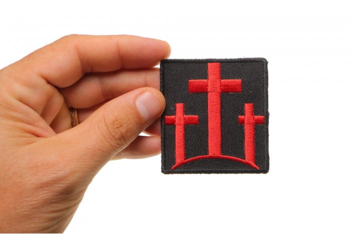 Three Crosses In Red Christian Patch shown on hand for size comparison