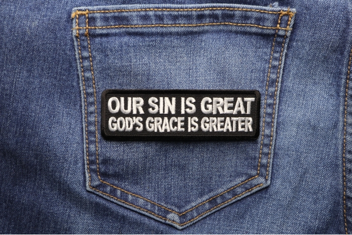 Our Sin Is Great Gods Grace Is Greater Patch shown on jeans