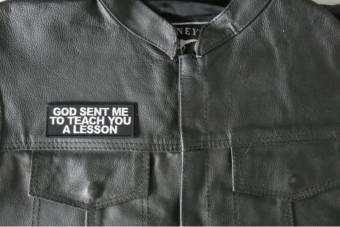 God Sent me to Teach you a Lesson Patch - 4x1.5 inch - Embroidered Iron on Patch shown on leather vest
