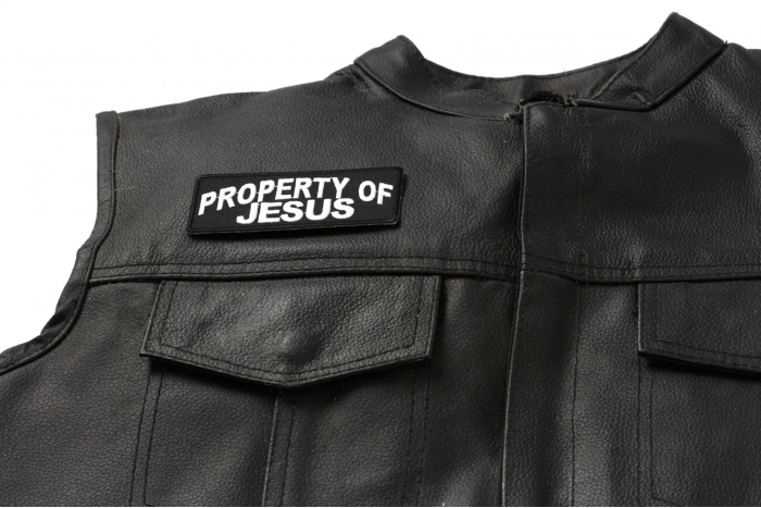 Property Of Jesus Christian Patch - 4x1.5 inch. Embroidered Iron on Patch shown on leather vest