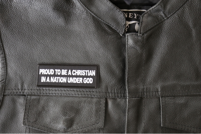 Proud to be a Christian in a Nation Under God Patch - 4x1.5 inch - Embroidered Iron on Patch shown on leather vest