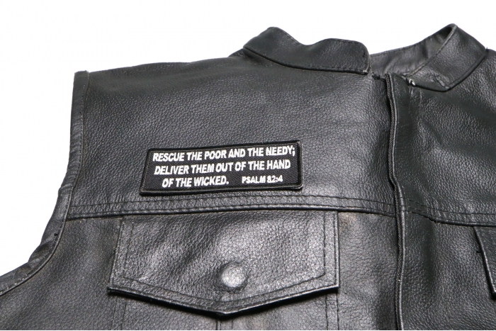 Rescue The Poor and The Needy. Deliver Them Out of The Hand of The Wicked. Psalm 82 4 Patch - 4x1.5 inch. Embroidered Iron on Patch shown on leather vest