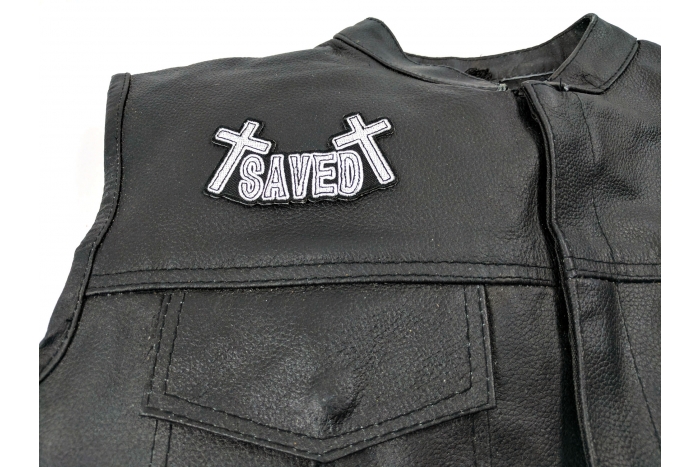 SAVED Patch - 4x2.25 inch. Embroidered Iron on Patch shown on leather vest