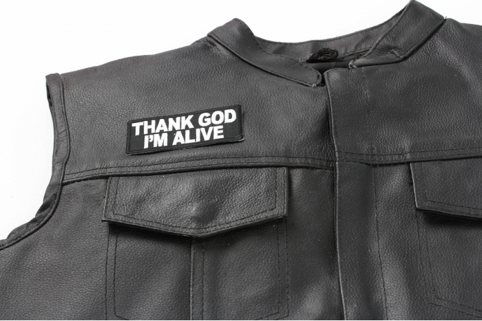 Thank God I'm Alive Patch - 4x1.5 inch. Embroidered Iron on Patch shown on leather vest