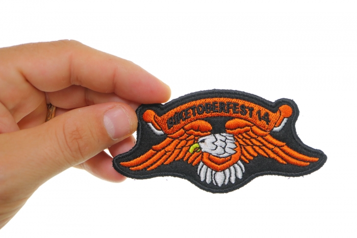 Biketoberfest 2014 Orange Downwing Eagle Biker Patch shown on hand for size comparison