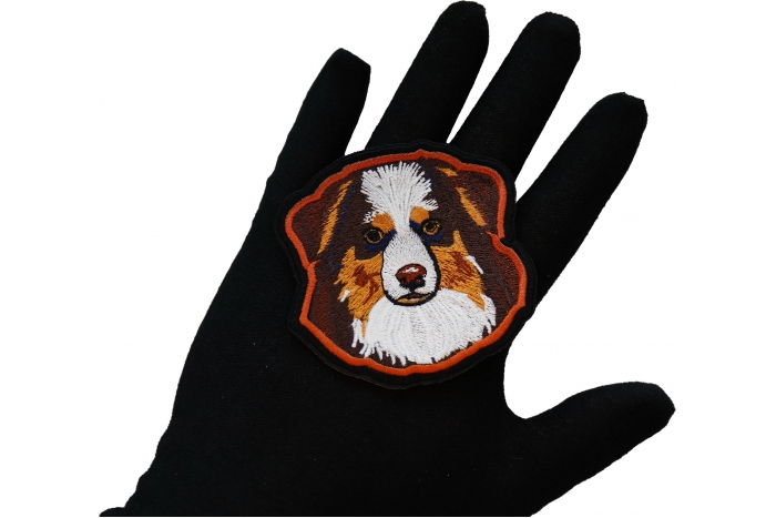 Australian Shepard Dog Iron on Patch shown on hand for size comparison
