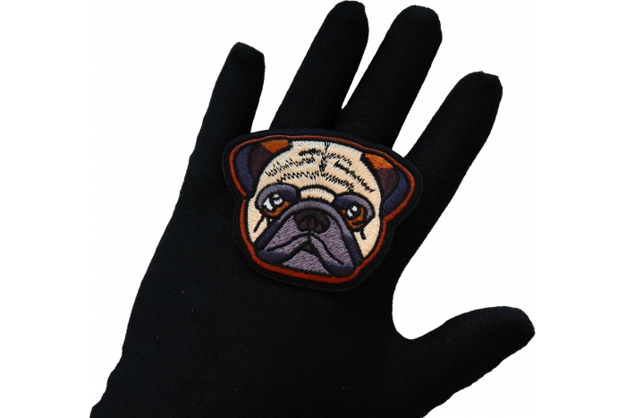Cute Pug Dog Iron on Patch shown on hand for size comparison