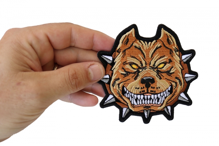Pit Bull Spike Collar Iron on Patch shown on hand for size comparison