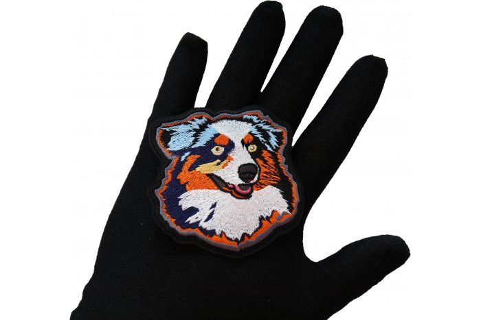 Proud Australian Shepherd Dog Iron on Patch shown on hand for size comparison