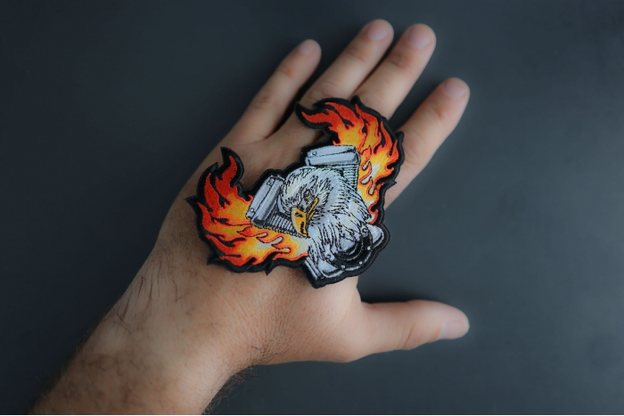 Eagle Engine Flames Biker Patch shown on hand for size comparison