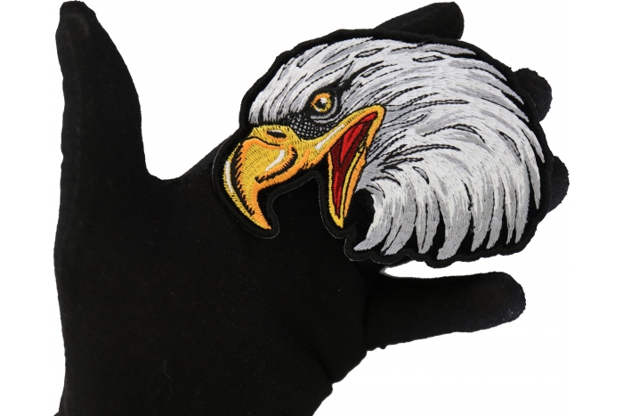 Eagle Head Left facing Iron on Biker Patch shown on hand for size comparison