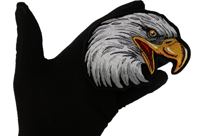 Eagle Head Facing Right Iron on Biker Patch shown on hand for size comparison