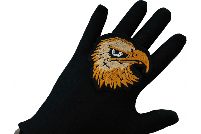 Eagle Head Iron on Patch shown on hand for size comparison